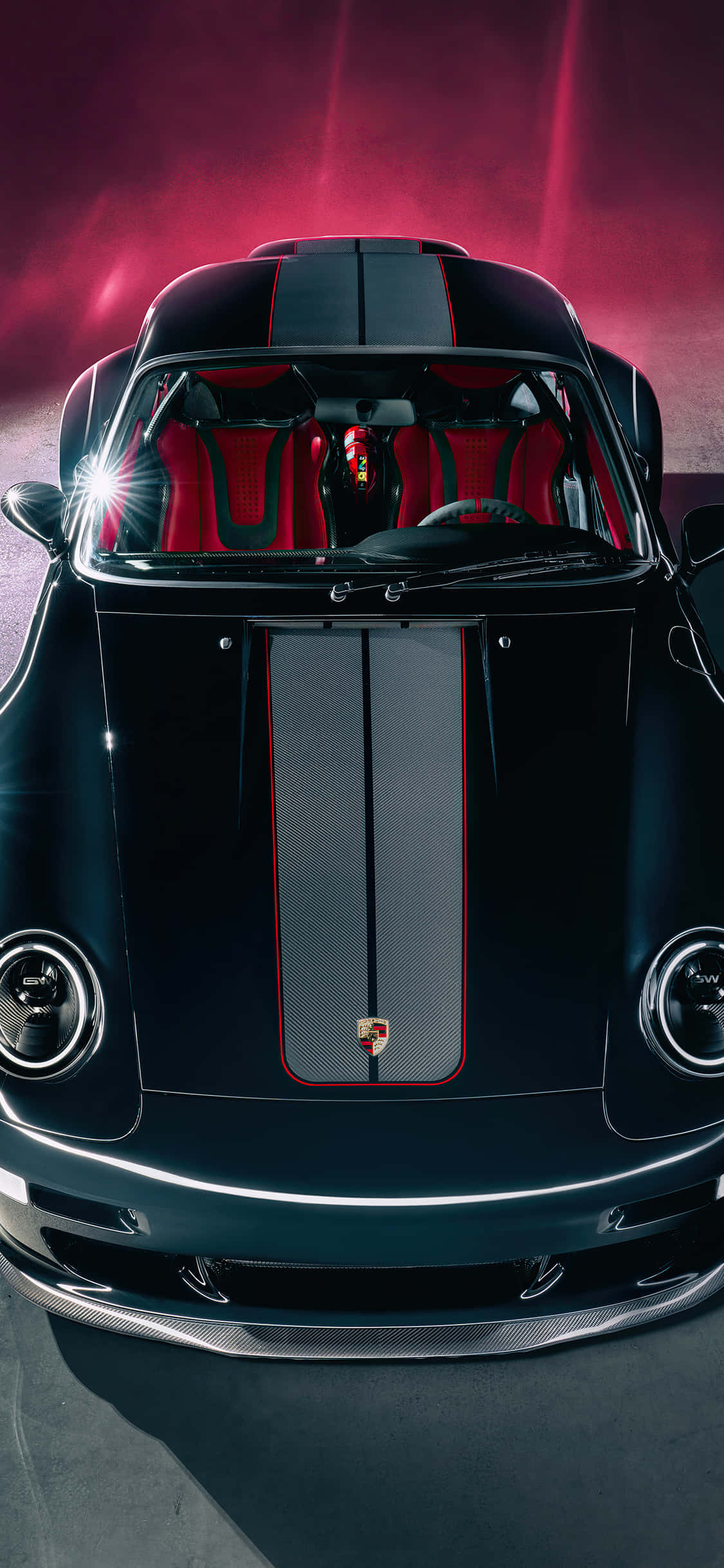Porsche iPhone 桌布 壁紙 — 一輛時尚的黑色保時捷跑車，配備紅色內飾和賽車條紋，在戲劇性的粉紅色工作室燈光下閃耀。