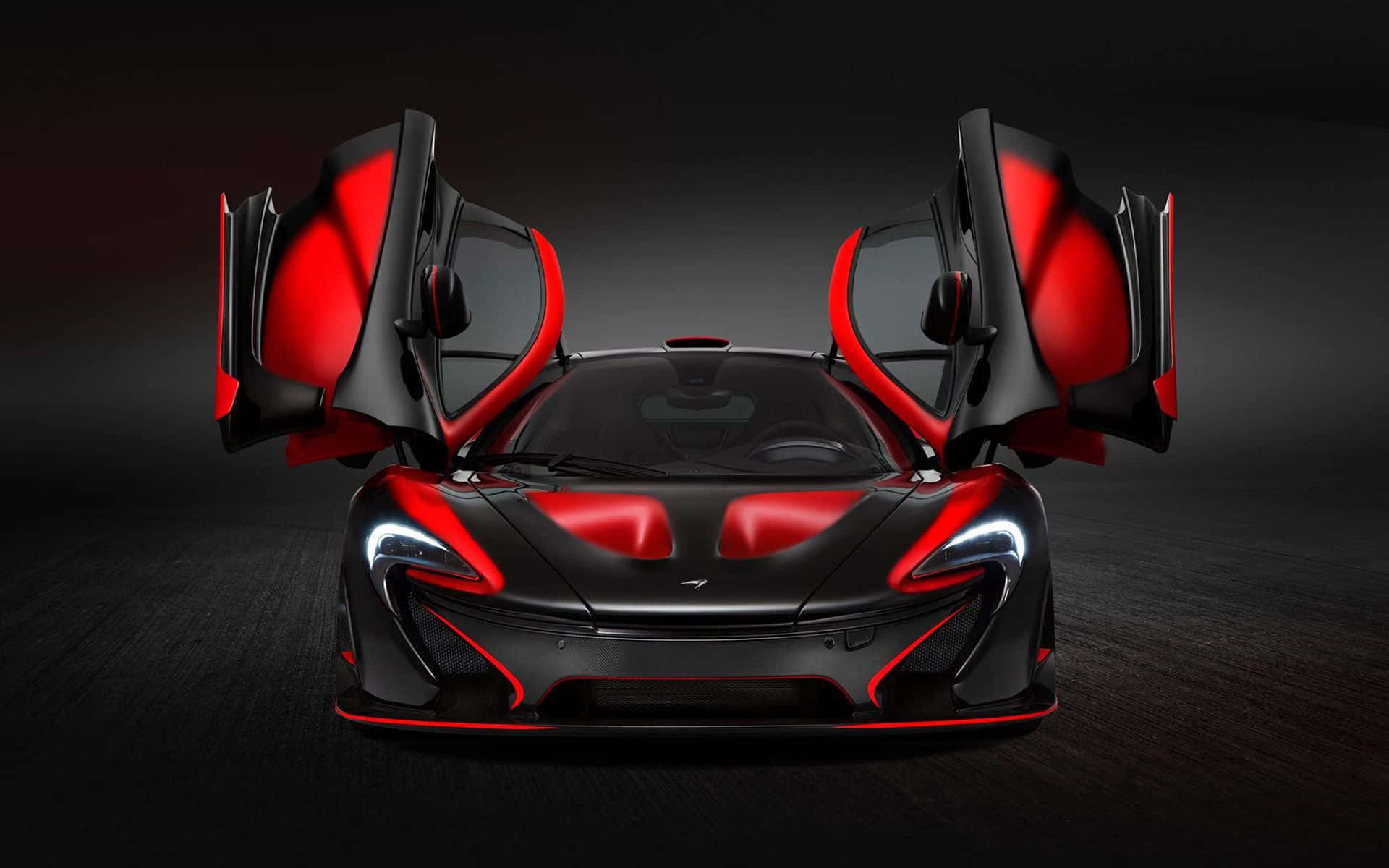 Mclaren P1 桌布 壁紙 — 一輛時尚的黑色和紅色McLaren超級跑車，在黑暗的工作室背景下打開鷗翼車門。