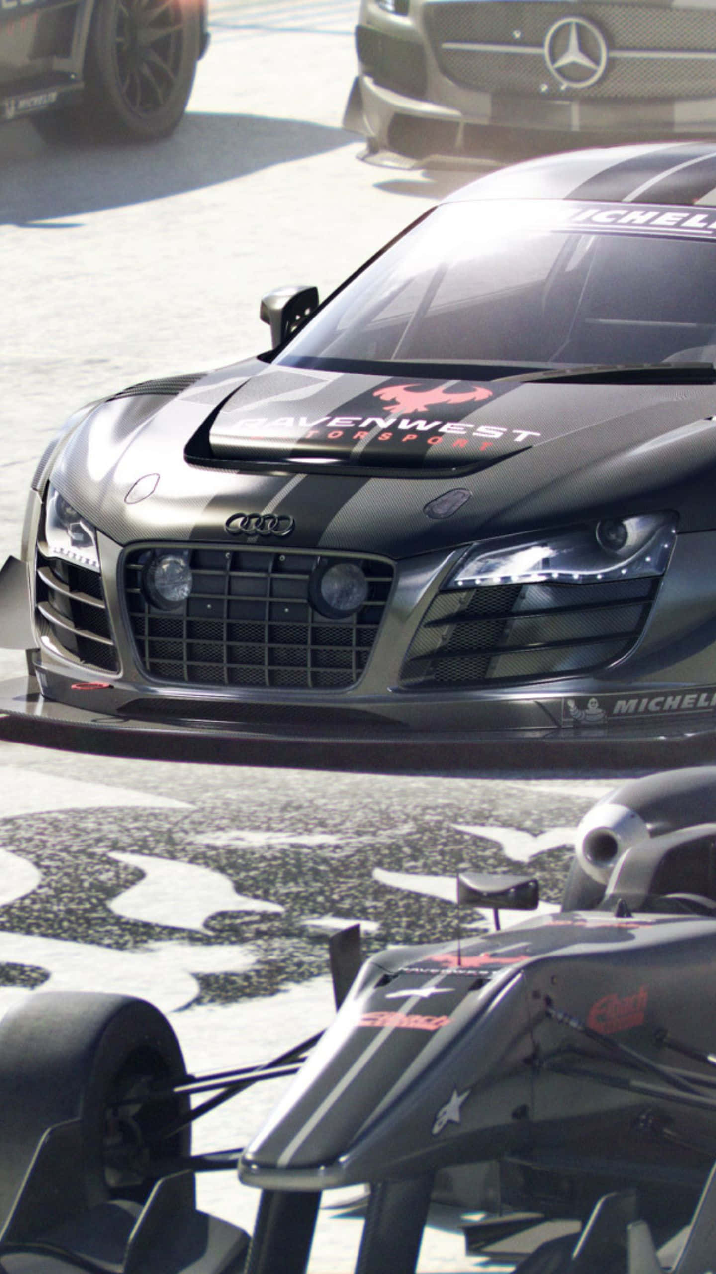 Android Grid Autosport 桌布 壁紙 — 一輛時尚的黑色奧迪R8賽車帶有紅色點綴，在賽道上佔據主導地位，其激進的設計和贊助商貼紙引人注目。