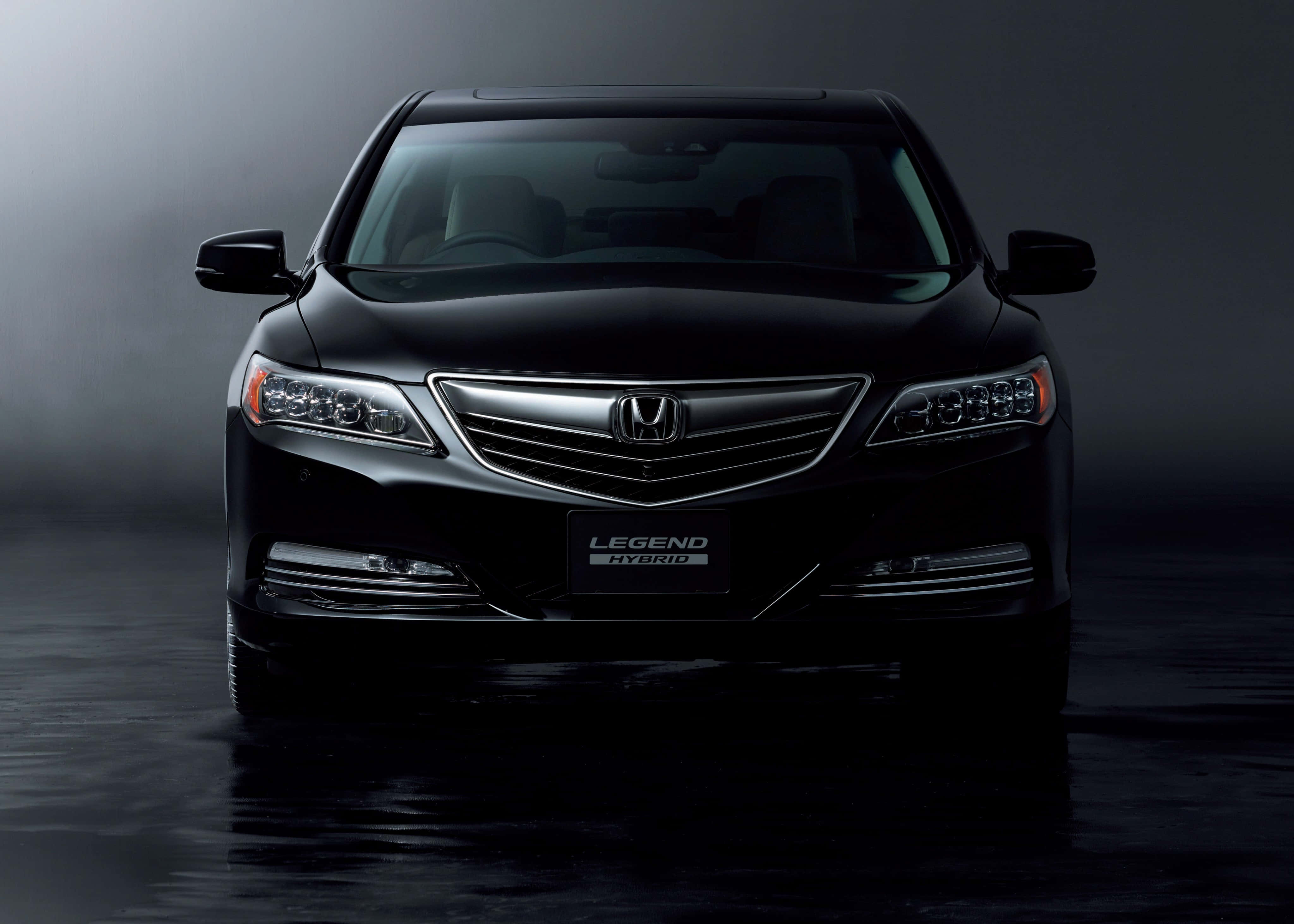 Honda Legend 桌布 壁紙 — 一輛時尚的黑色本田 Legend Hybrid 轎車在戲劇性的攝影棚燈光下閃耀，下方是反射性的濕潤路面。