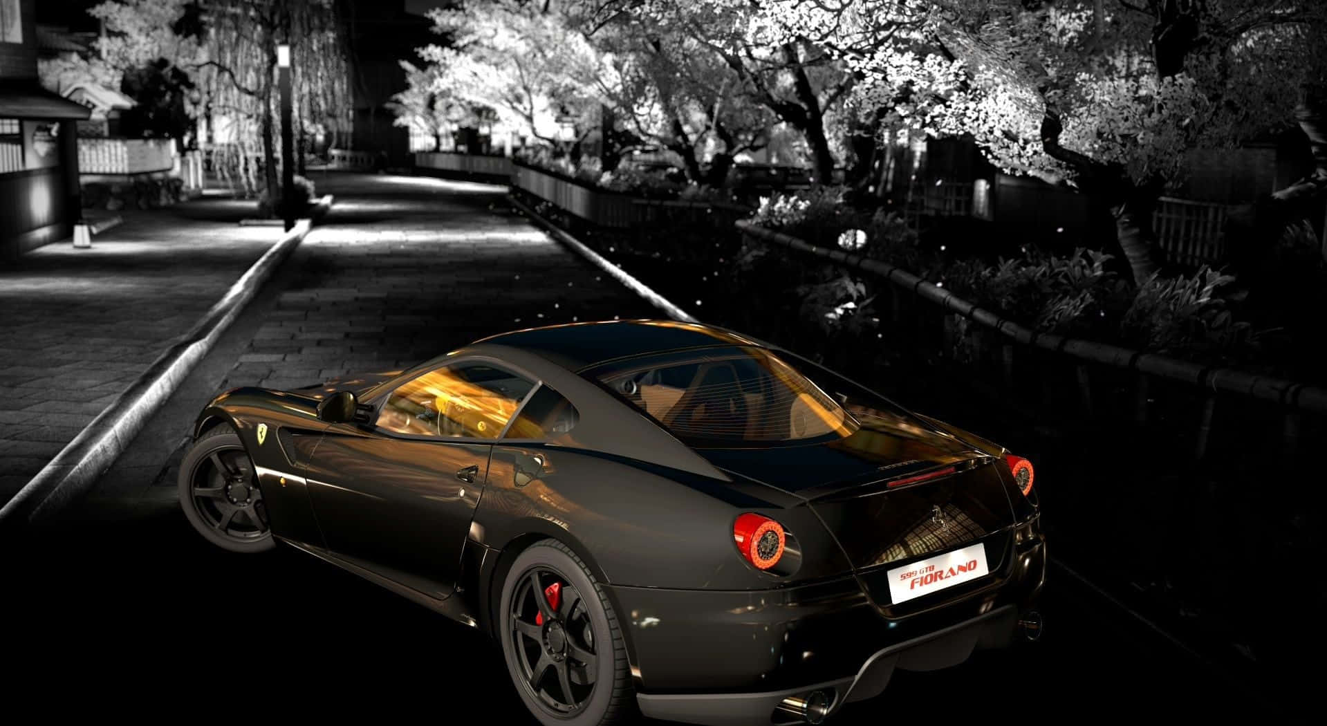 Ferrari 599 Gtb Fiorano 桌布 壁紙 — 一輛時尚的黑色法拉利跑車在夜間停泊在亮燈的櫻花樹下，車內燈光閃爍。