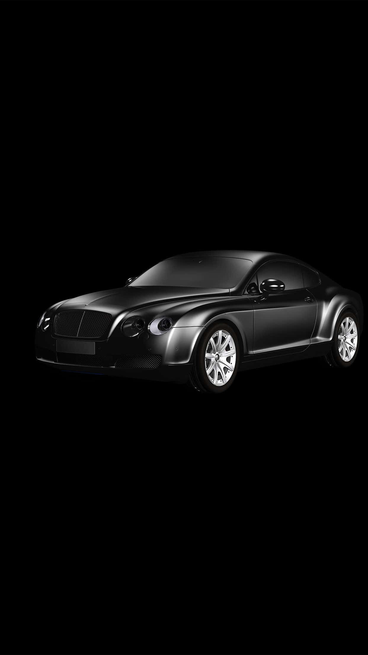 bentley HD 桌布 壁紙 — 一輛時尚的黑色賓利 Continental GT 雙門轎跑車在純黑色背景下的攝影棚燈光中閃耀。