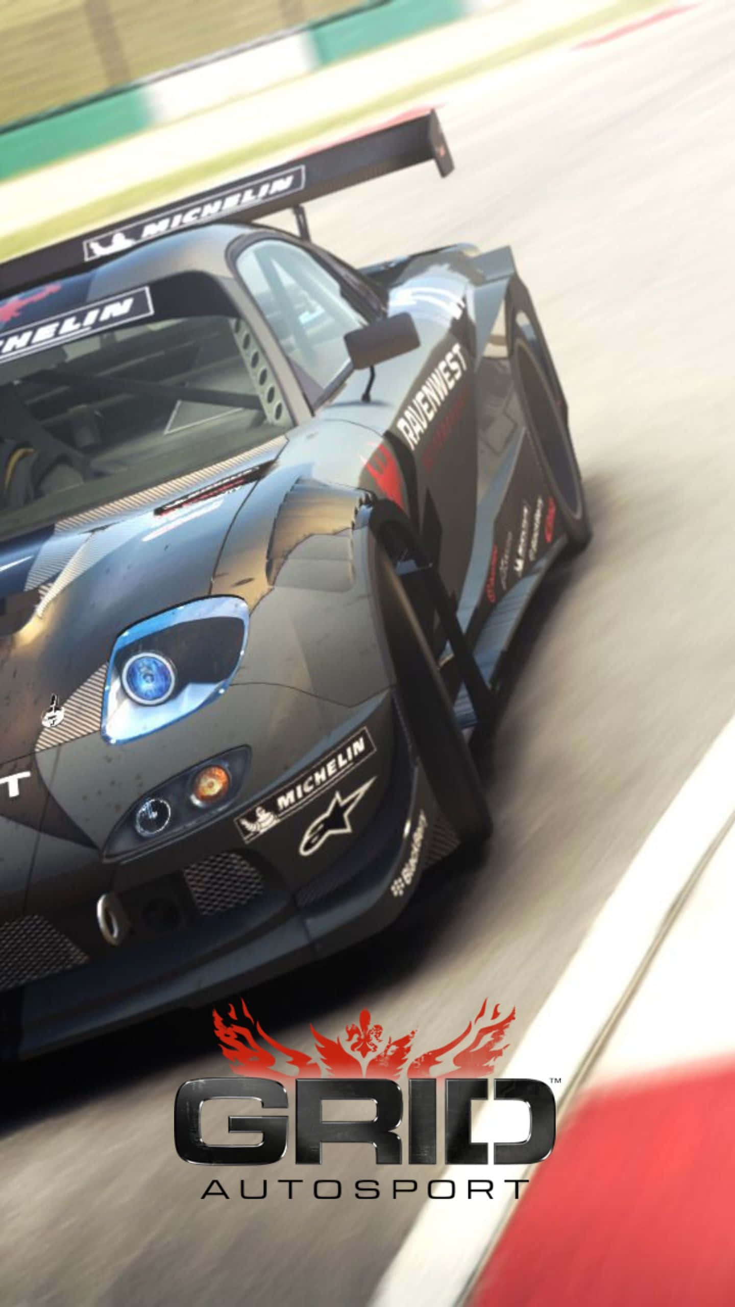 Android Grid Autosport 桌布 壁紙 — 一輛時尚的黑色賽車在賽道上疾馳，帶有模糊的動感和可見的米其林品牌標誌。