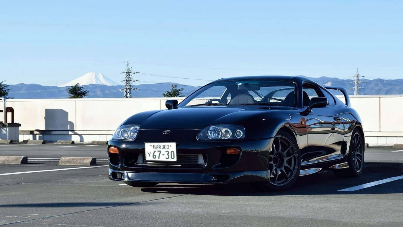 黑色跑車停放，背景為富士山，天空湛藍 — Toyota Supra Mk4 壁紙