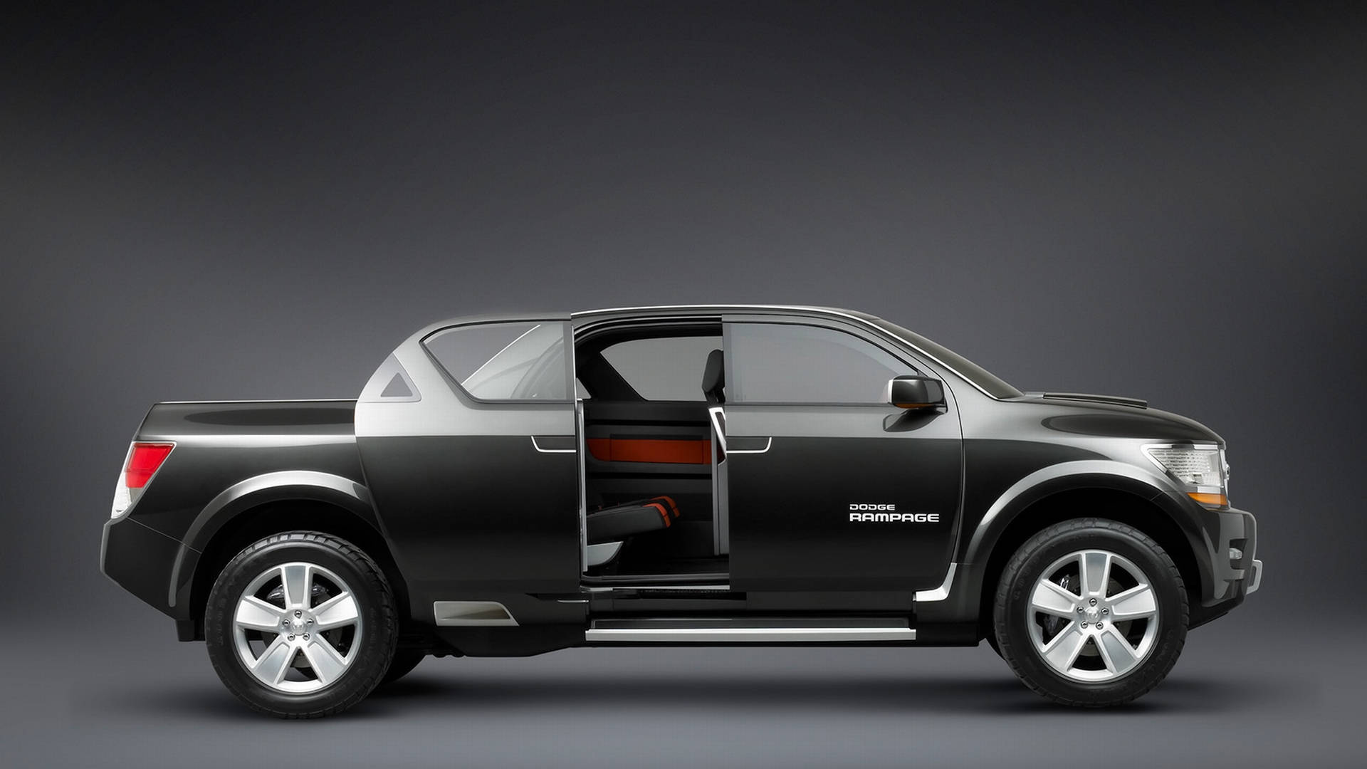 dodge iPhone 桌布 壁紙 — 一輛時尚的黑色道奇Rampage皮卡車，車門打開，露出紅色內飾，背景為深灰色工作室。