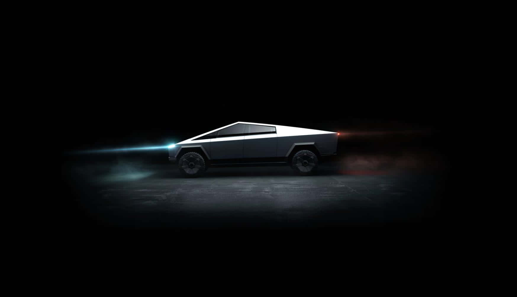 Tesla Cybertruck 桌布 壁紙 — 一輛未來感十足的銀色Tesla Cybertruck在黑暗中滑行，帶有發光的藍色頭燈和紅色尾燈。