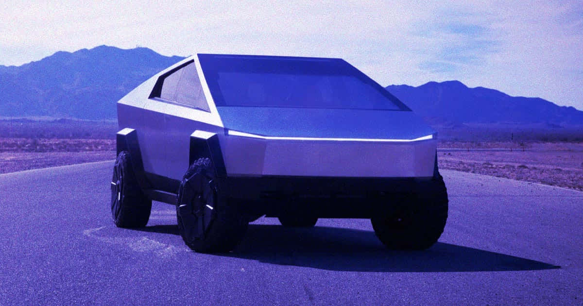Tesla Cybertruck 桌布 壁紙 — 一輛未來感十足的銀色Tesla Cybertruck停泊在沙漠公路上，背景是藍天白雲下的山脈。