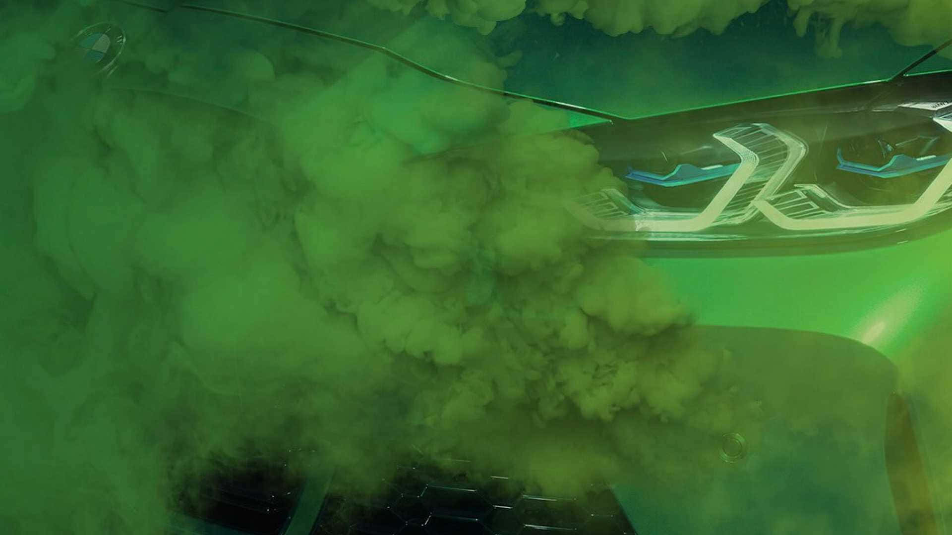 煙動圖 桌布 壁紙 — 一輛未來汽車的發光車頭燈穿透濃厚的綠色煙霧，營造出陰鬱而富有氛圍的場景。