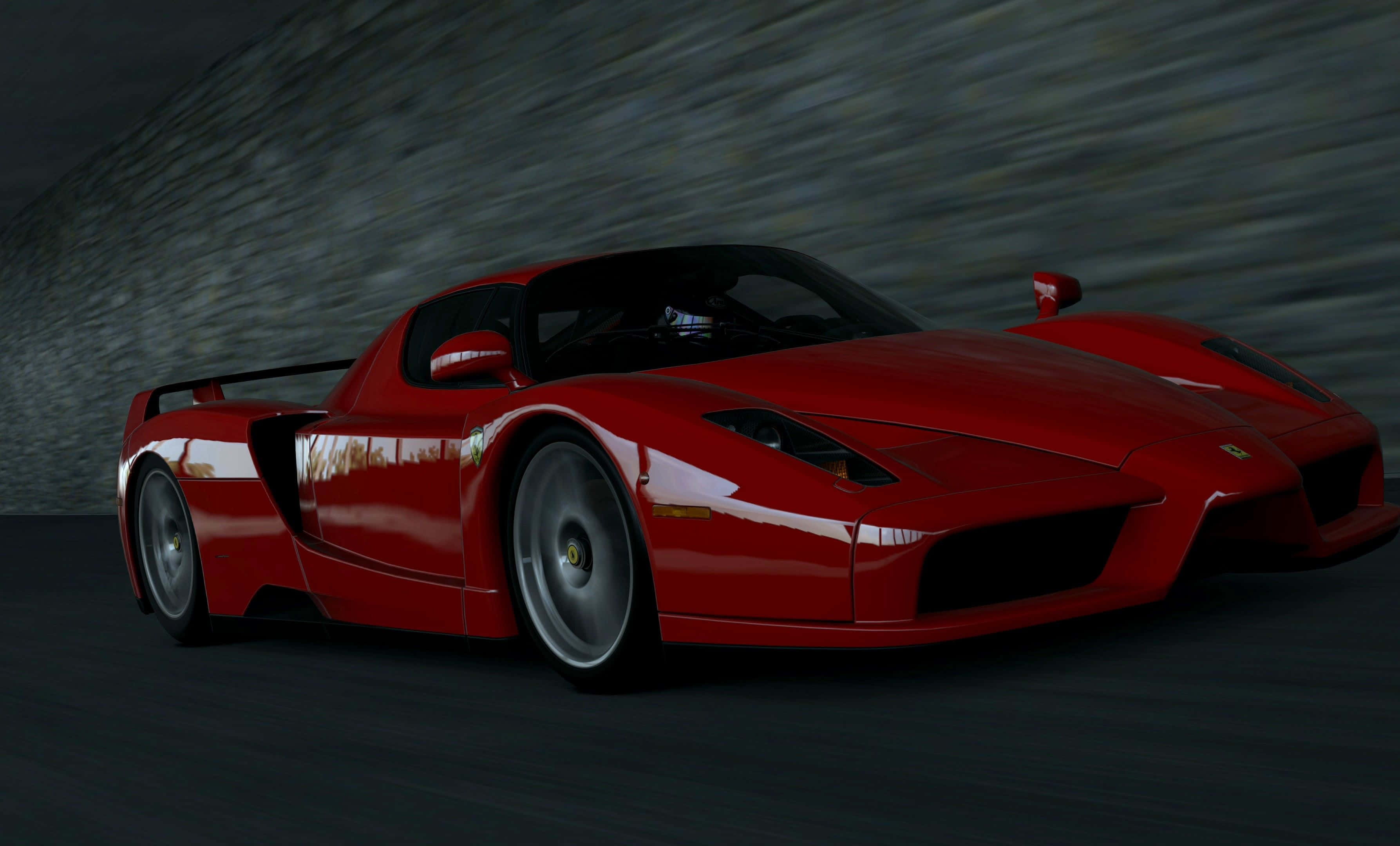 Ferrari Enzo 桌布 壁紙 — 一輛流線型紅色法拉利Enzo在黑暗隧道中疾馳，身後牆壁留下動態模糊的條紋。