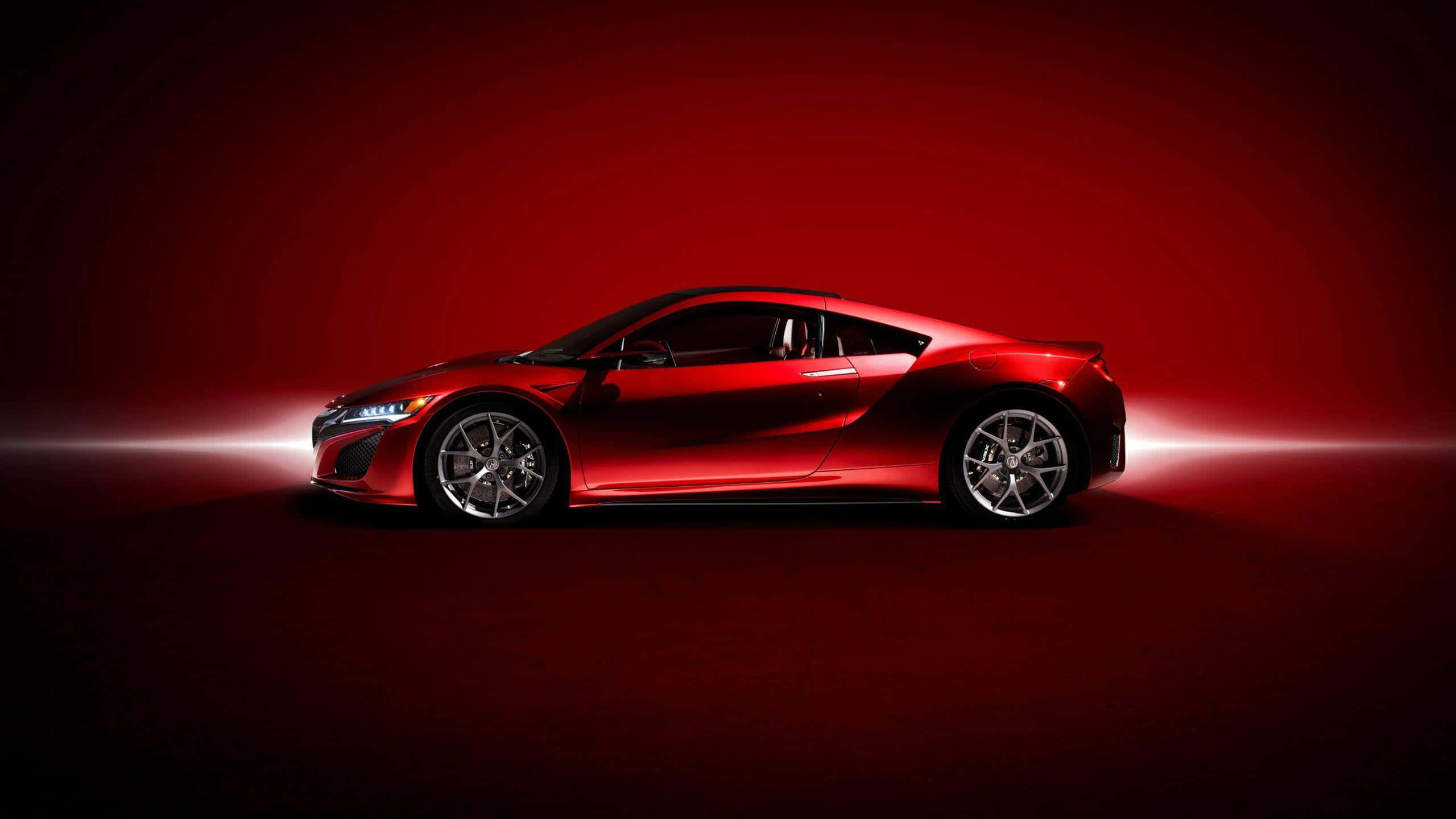 Acura Nsx 桌布 壁紙 — 一輛流線型紅色跑車在深紅色漸變背景前，在戲劇性的攝影棚燈光下閃耀。