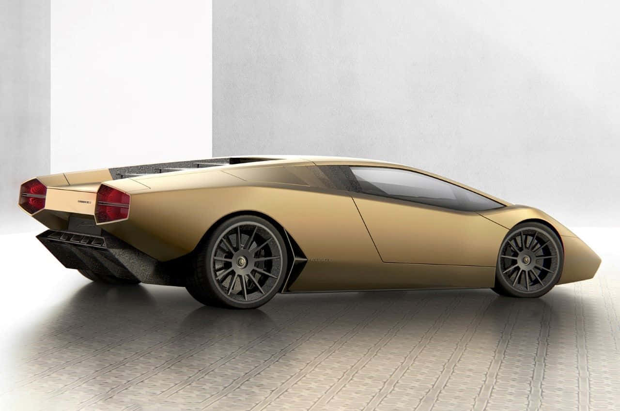 Minimalist Car 桌布 壁紙 — 一輛流線型金色藍寶堅尼概念車，採用棱角設計和黑色車輪，停放在極簡風格的工作室中，地板為混凝土，牆壁為白色。