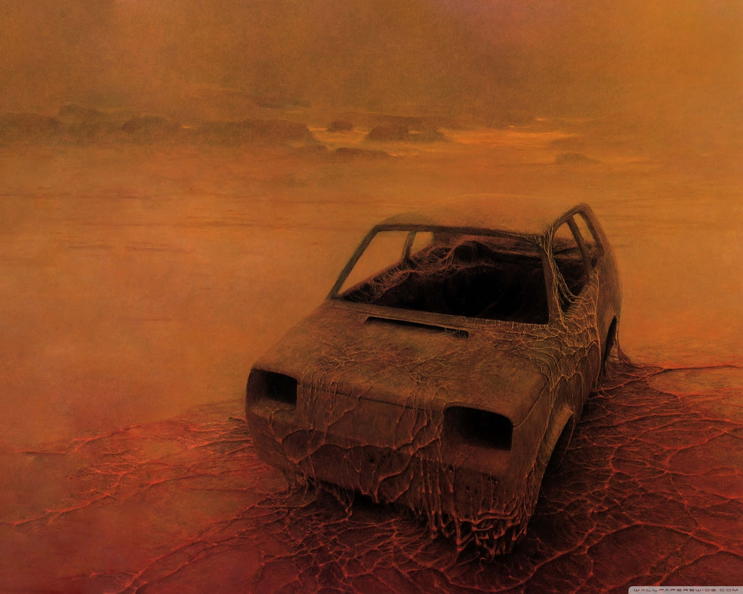 Abandoned 桌布 壁紙 — 一輛生鏽的廢棄汽車停在龜裂的沙漠中，天空朦朧橙色。