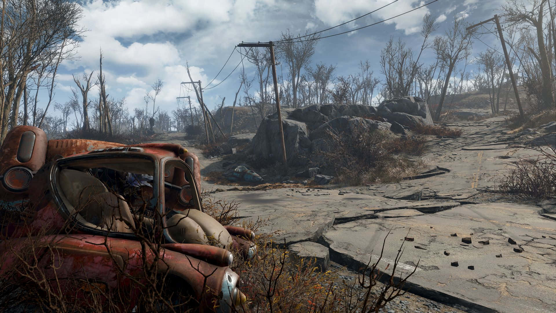 Fallout 4 Wasteland 桌布 壁紙 — 一輛生鏽的紅色汽車被遺棄在一條龜裂的道路上，周圍是荒涼的末日後廢土，有光禿禿的樹木和斷裂的電線。