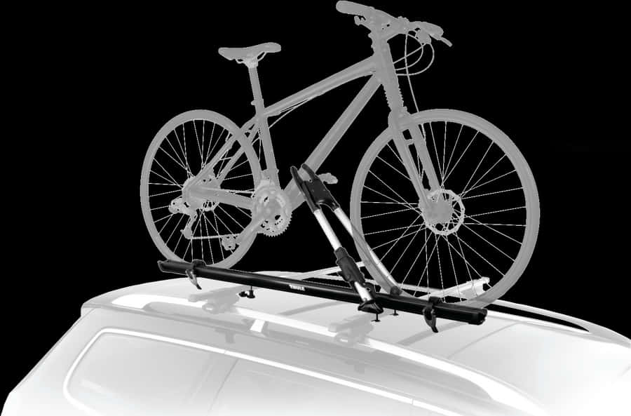 腳踏車 桌布 壁紙 — 一輛登山自行車安裝在白色車頂的黑色行李架上，背景為純黑色。