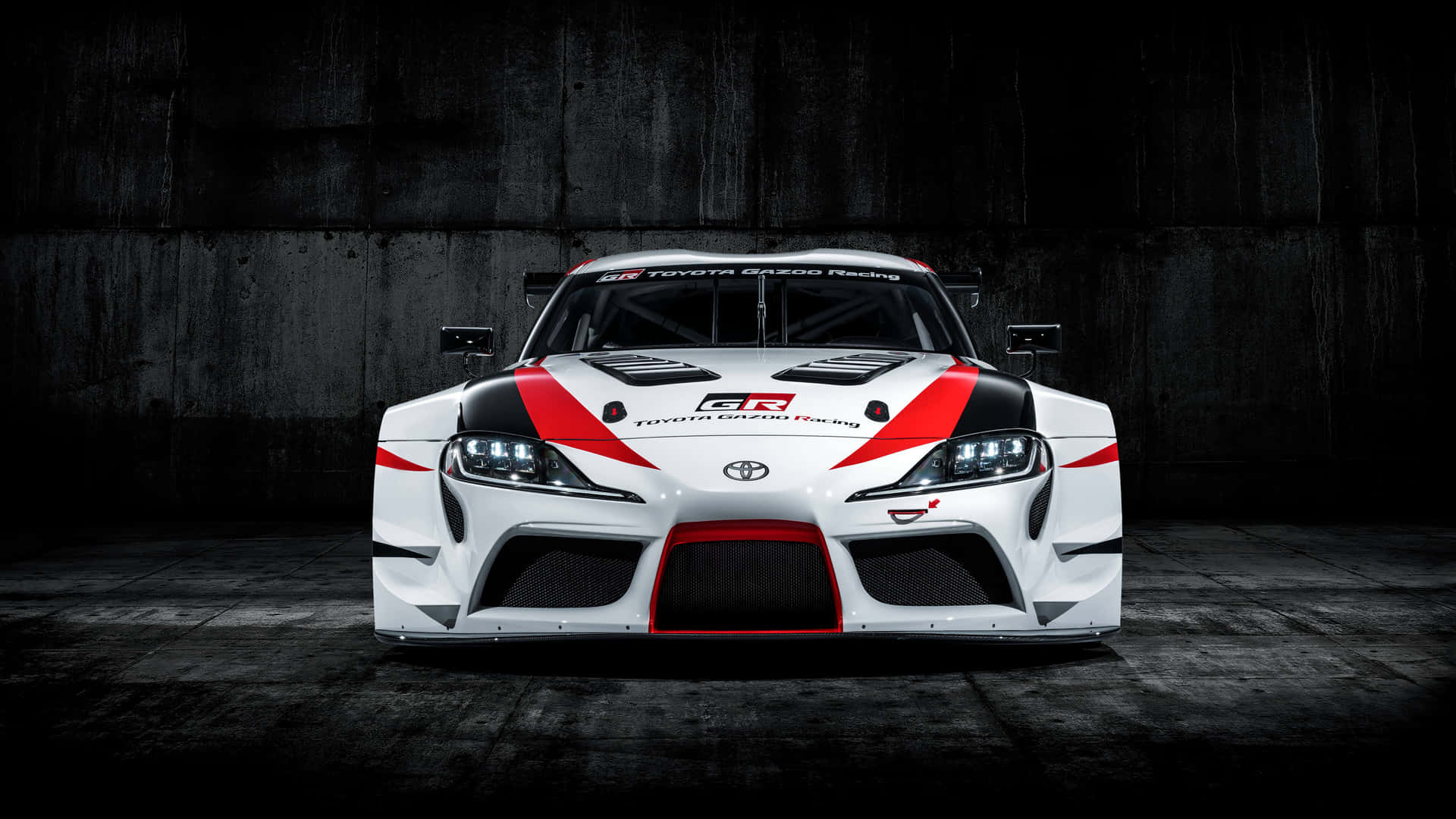 黑暗混凝土車庫中的白色、紅色和黑色豐田GR Supra賽車。 — Toyota Supra Mk4 壁紙