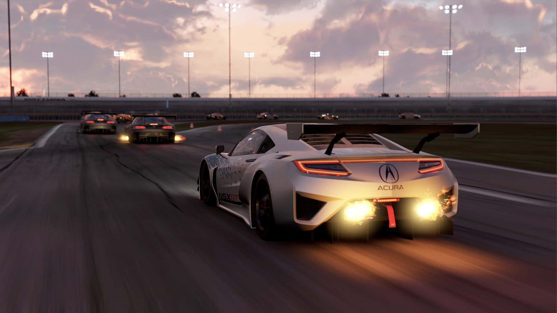 HD Project Cars 2 桌布 壁紙 — 一輛白色Acura賽車在黃昏時分帶著發光的尾燈在賽道上奔馳，其他賽車在體育場燈光下領先。
