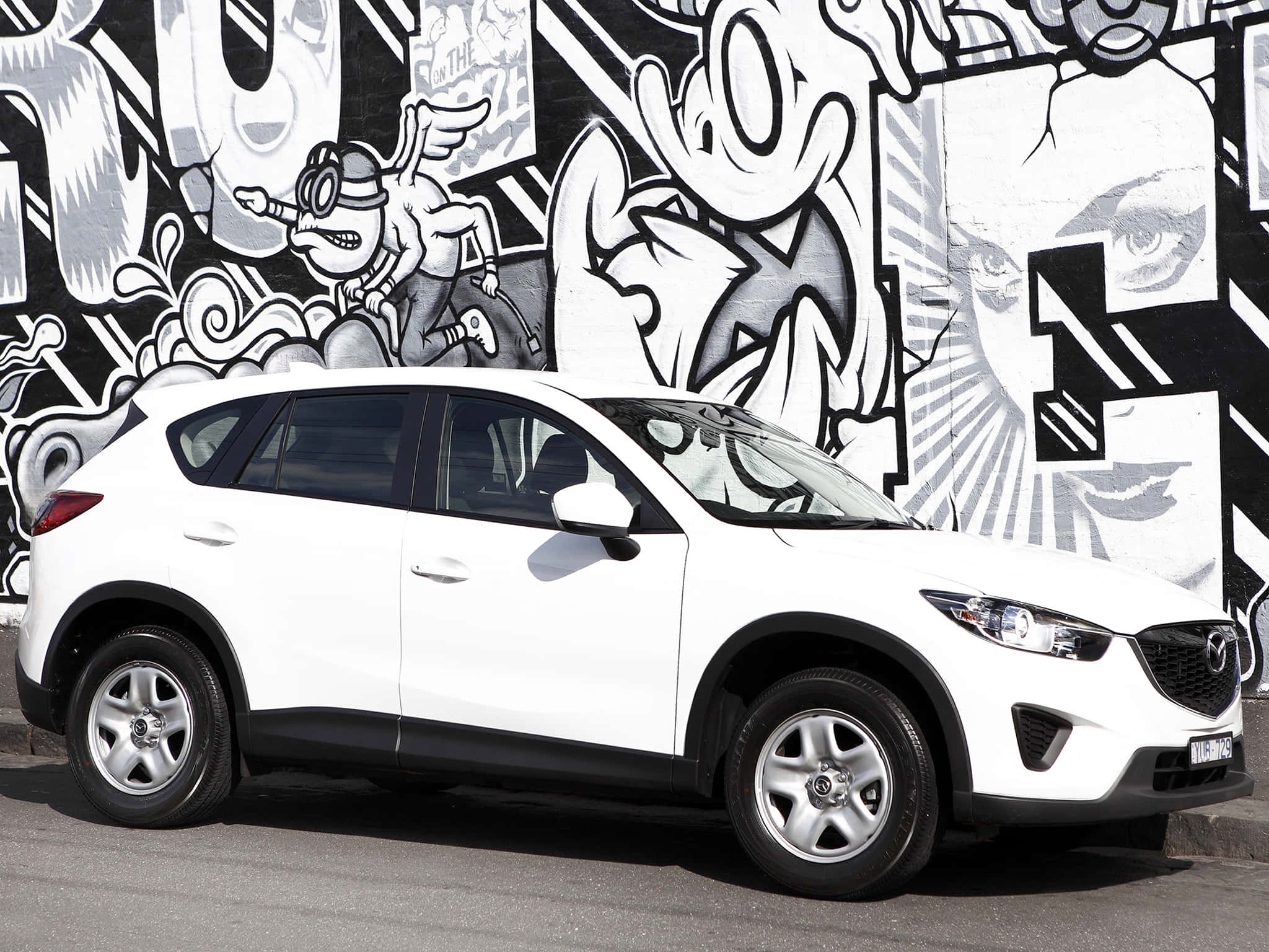 Mazda Cx-5 桌布 壁紙 — 一輛白色Mazda CX-5 SUV停在一幅大膽的黑白塗鴉牆前。