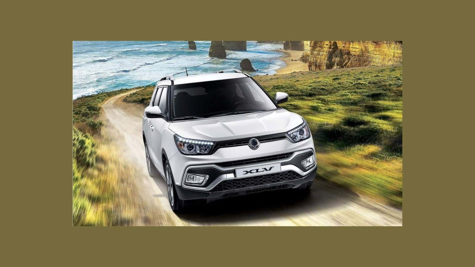 Ssangyong 桌布 壁紙 — 一輛白色SUV沿著海岸泥路行駛，背景是拍岸的浪濤和岩石峭壁。