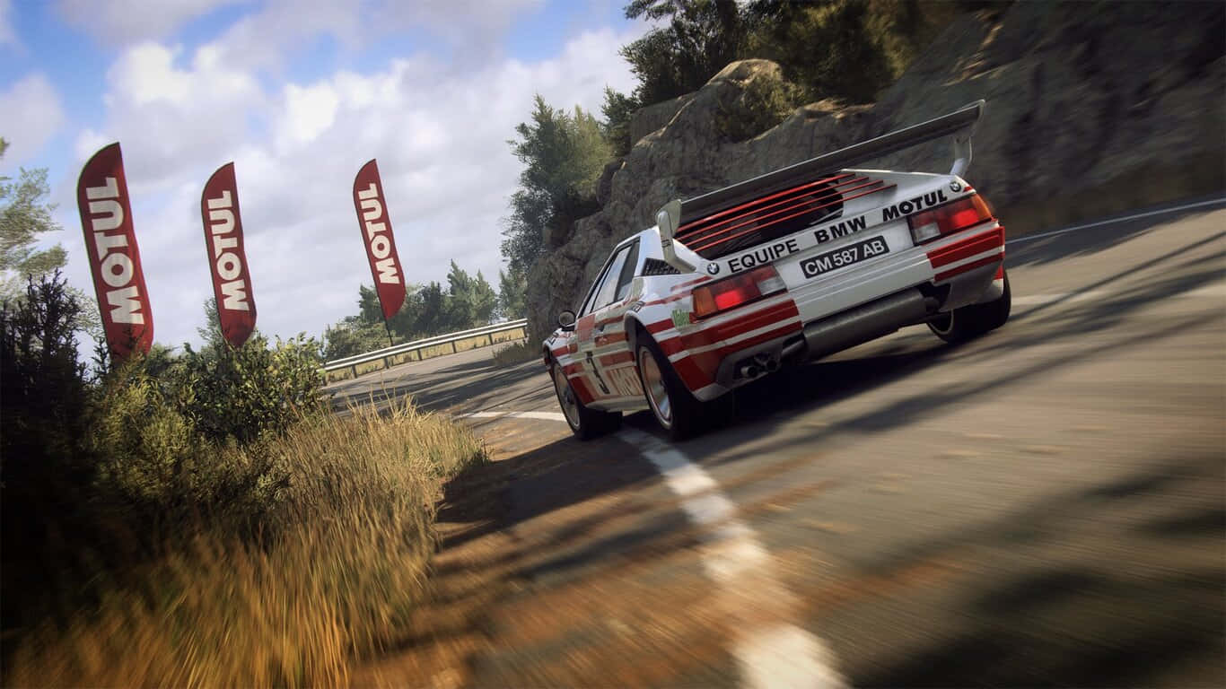 1366x768 Dirt Rally 桌布 壁紙 — 一輛白色和紅色的BMW拉力賽車在明亮的天空下，沿著蜿蜒的山路疾馳，MOTUL旗幟在茂密的綠植旁飄揚。