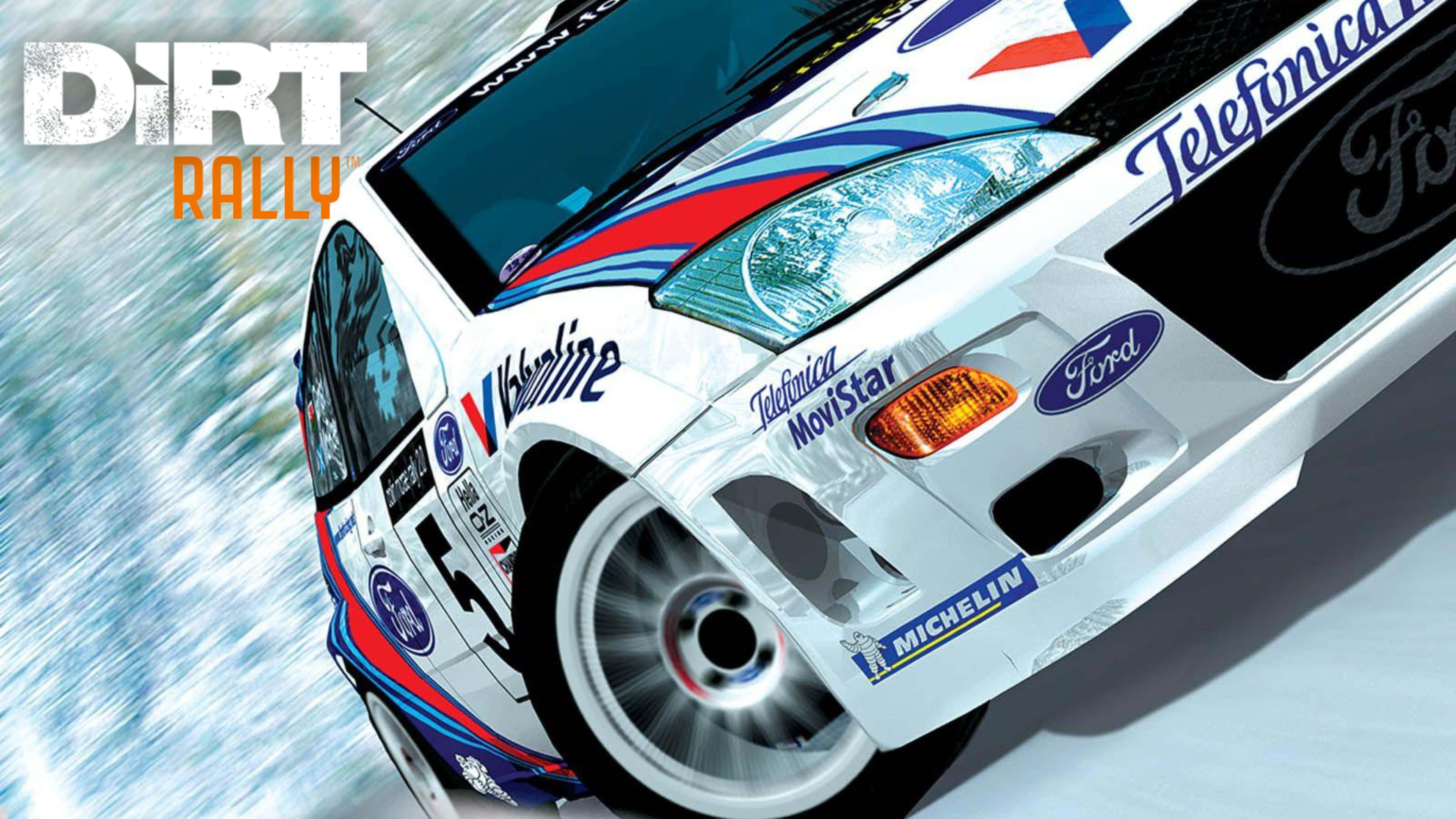 4K Dirt Rally 桌布 壁紙 — 一輛白色福特拉力賽車，帶有藍、紅、黑色塗裝，在雪地賽道上以動態低角度飛馳。