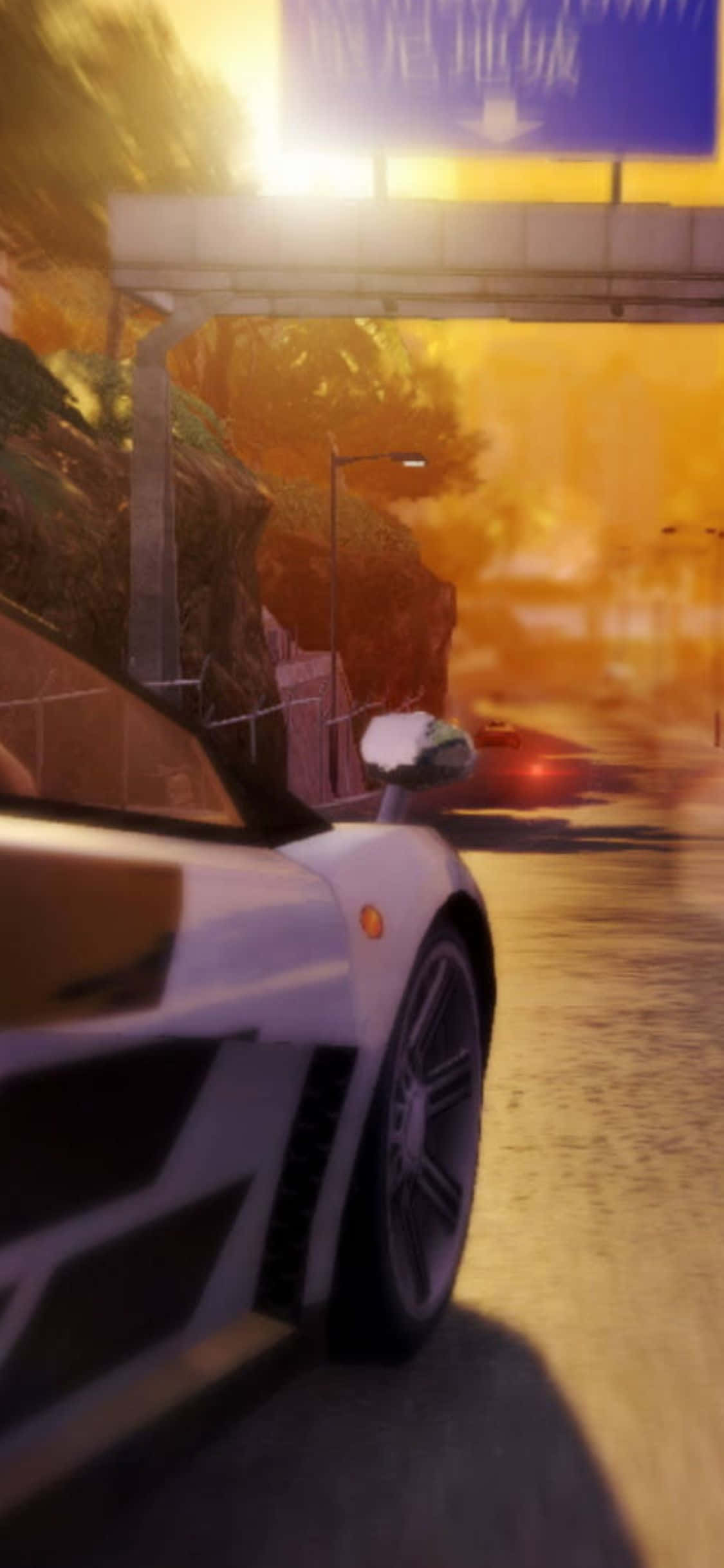 iPhone Xs Sleeping Dogs 桌布 壁紙 — 一輛白色跑車在日落時分，在發光的橙色高速公路天橋下高速行駛，帶有動態模糊效果。