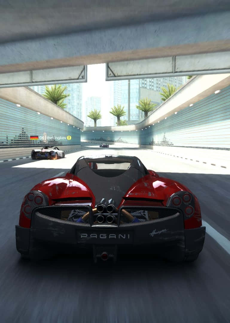 iPhone X Grid Autosport 桌布 壁紙 — 一輛紅色Pagani Huayra在未來主義的城市隧道中疾馳，前方可見棕櫚樹和摩天大樓。
