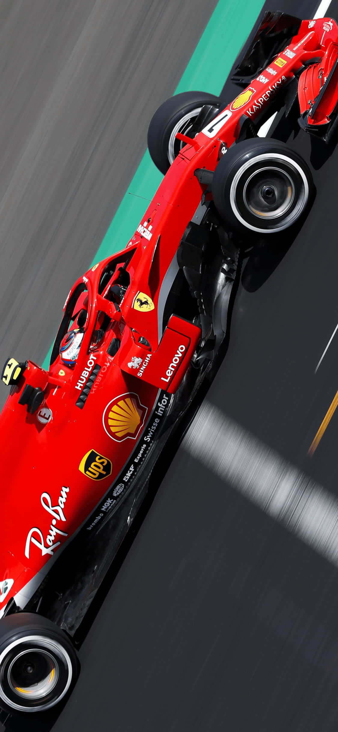 F1 2018 桌布 壁紙 — 一輛紅色法拉利F1賽車在賽道上疾馳，動態模糊強調高速。