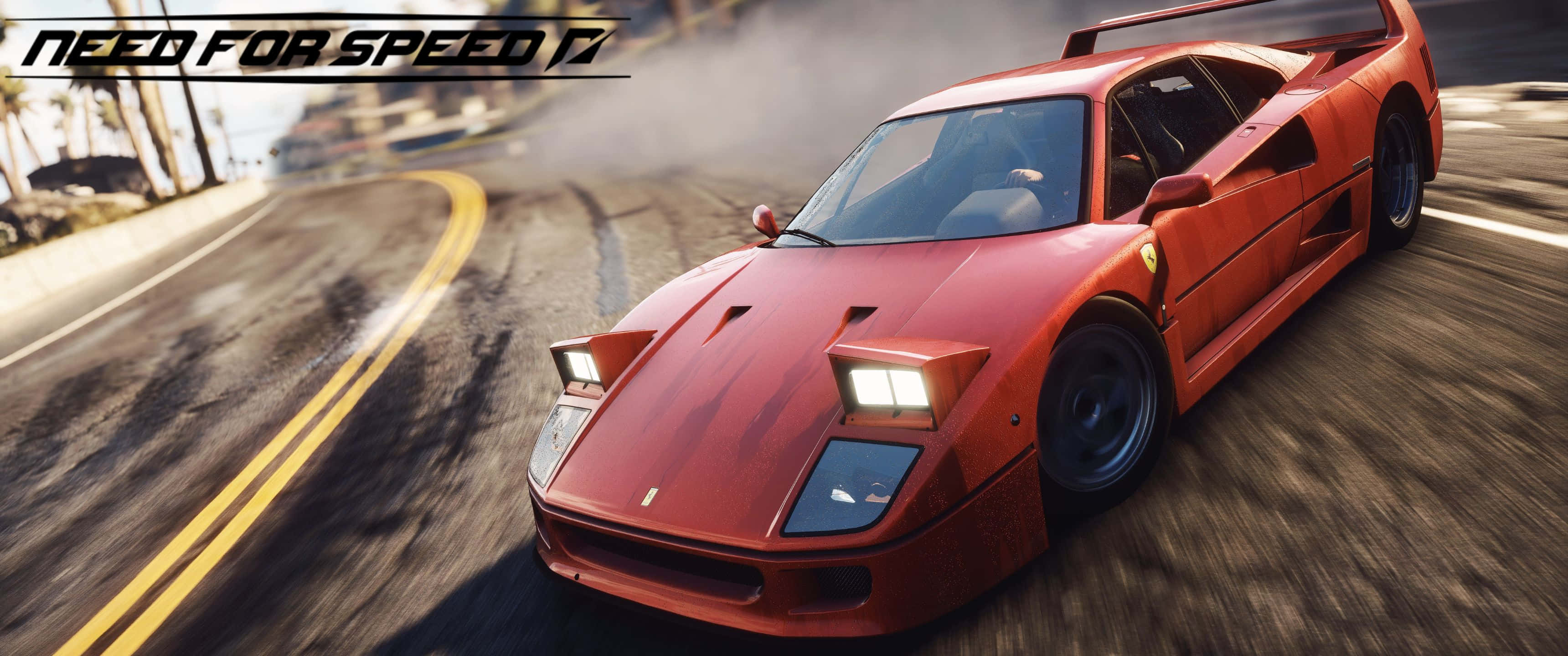 3440x1440p Need For Speed 桌布 壁紙 — 一輛紅色法拉利F40在棕櫚樹環繞的海岸道路上飄移，動態模糊傳達高速感。
