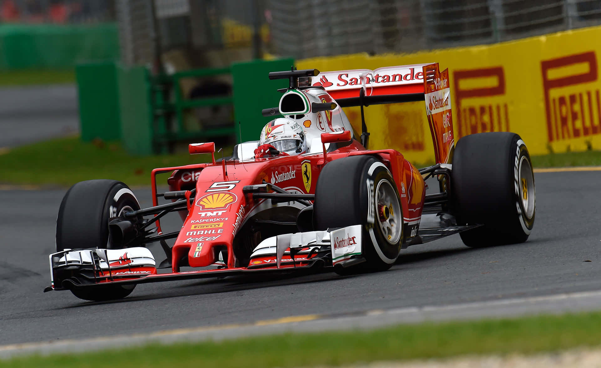 HD F1 2016 桌布 壁紙 — 一輛紅色法拉利一級方程式賽車（編號5）在有Pirelli和Santander品牌標識的濕滑賽道上比賽。