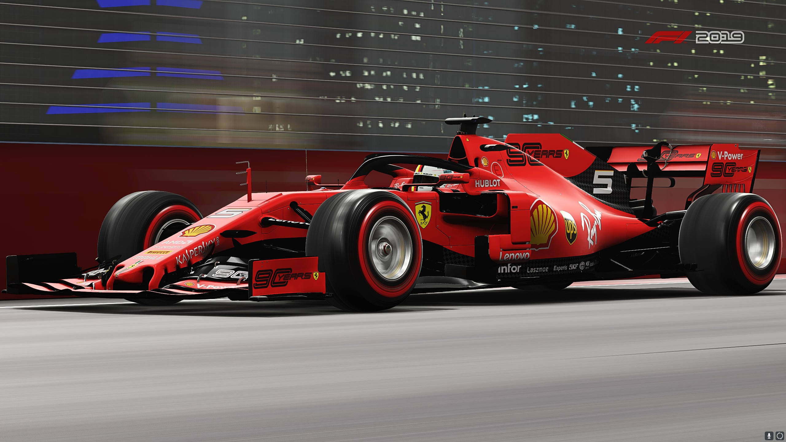 F1 2019 壁紙 桌布 壁紙 — 一輛紅色法拉利一級方程式賽車在夜間高速駛過模糊的城市景觀，背景中閃爍著發光的燈光條紋。