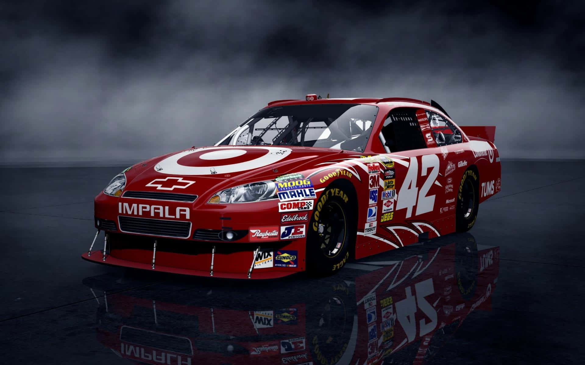 nascar 桌布 壁紙 — 一輛紅色雪佛蘭 Impala 賽車，車號 42，帶有贊助商貼紙，在戲劇性燈光下於反光的深色表面上閃閃發光。