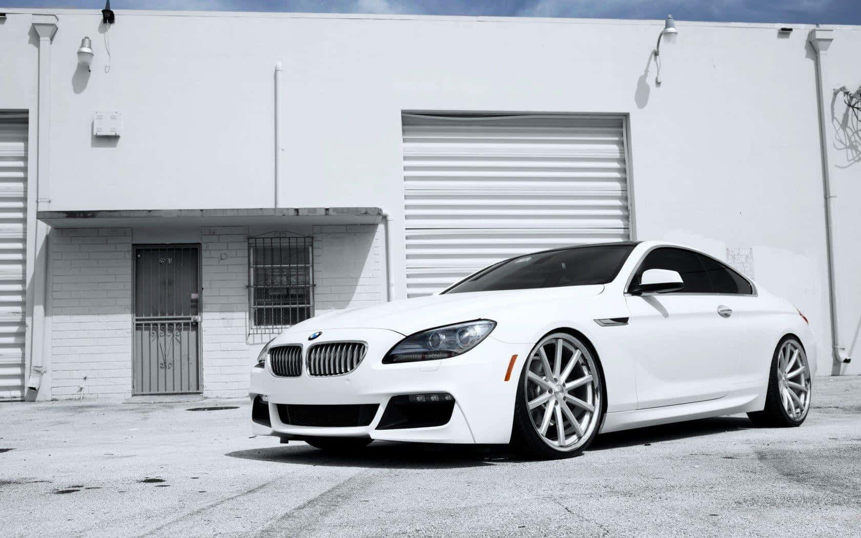 Bmw 6 Series 桌布 壁紙 — 一輛純白色BMW運動轎跑車停在純白色工業建築前，在明亮日光下。
