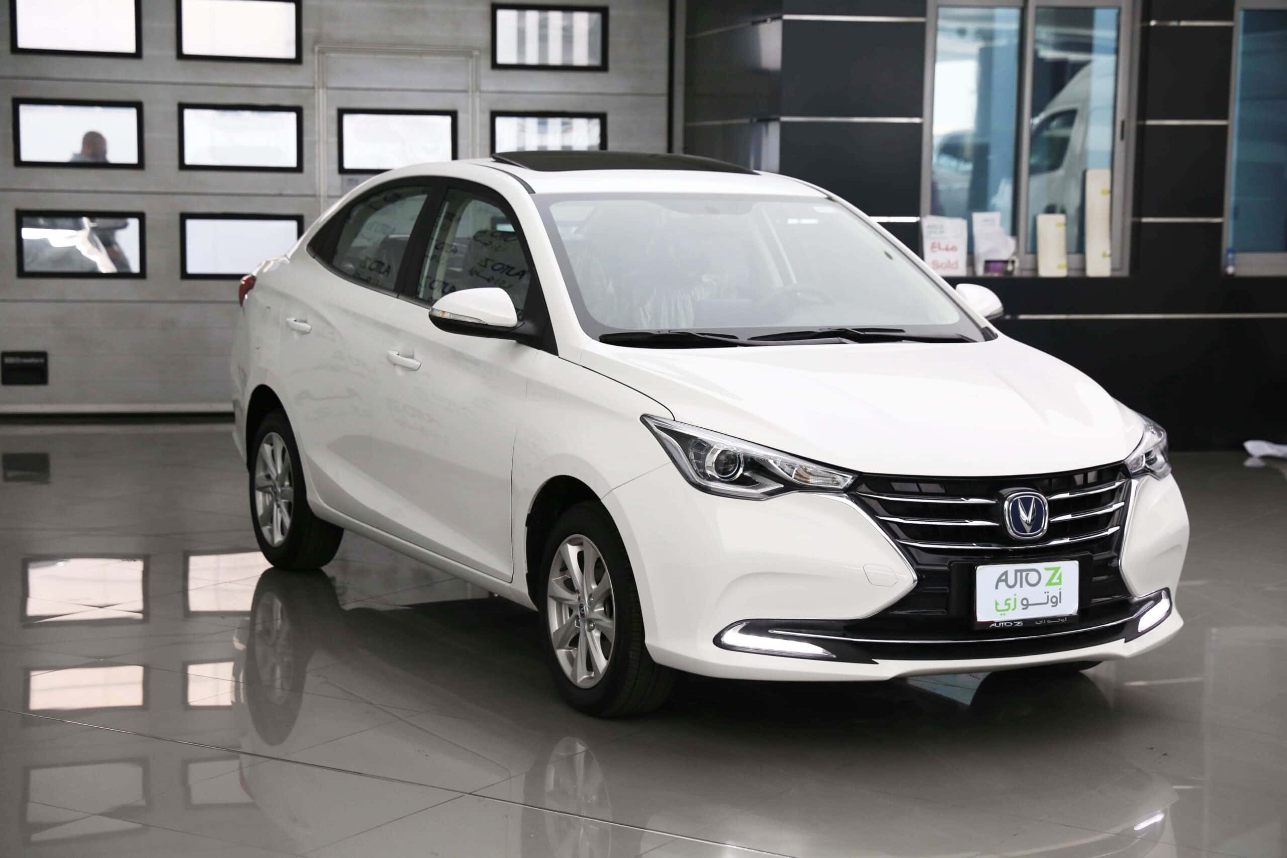 Changan 桌布 壁紙 — 一輛純白色轎車在光線明亮的時尚現代汽車經銷商展廳中閃閃發光，地板具有反射效果。