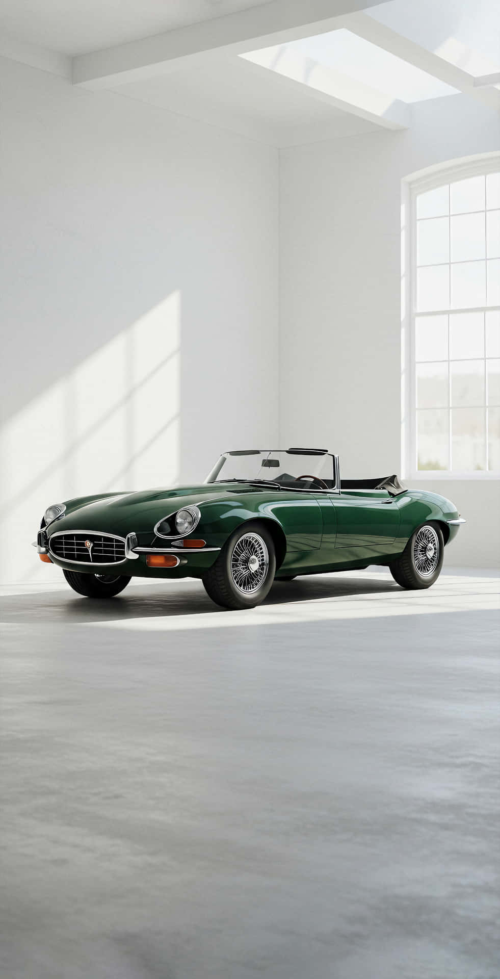 A vintage coupe shown in a clean soft background with simple forms and quiet elegance in a modern mi 壁紙 — 一輛經典綠色積架E-Type敞篷車在簡約白色工作室的大窗戶透進的自然光下閃閃發光。