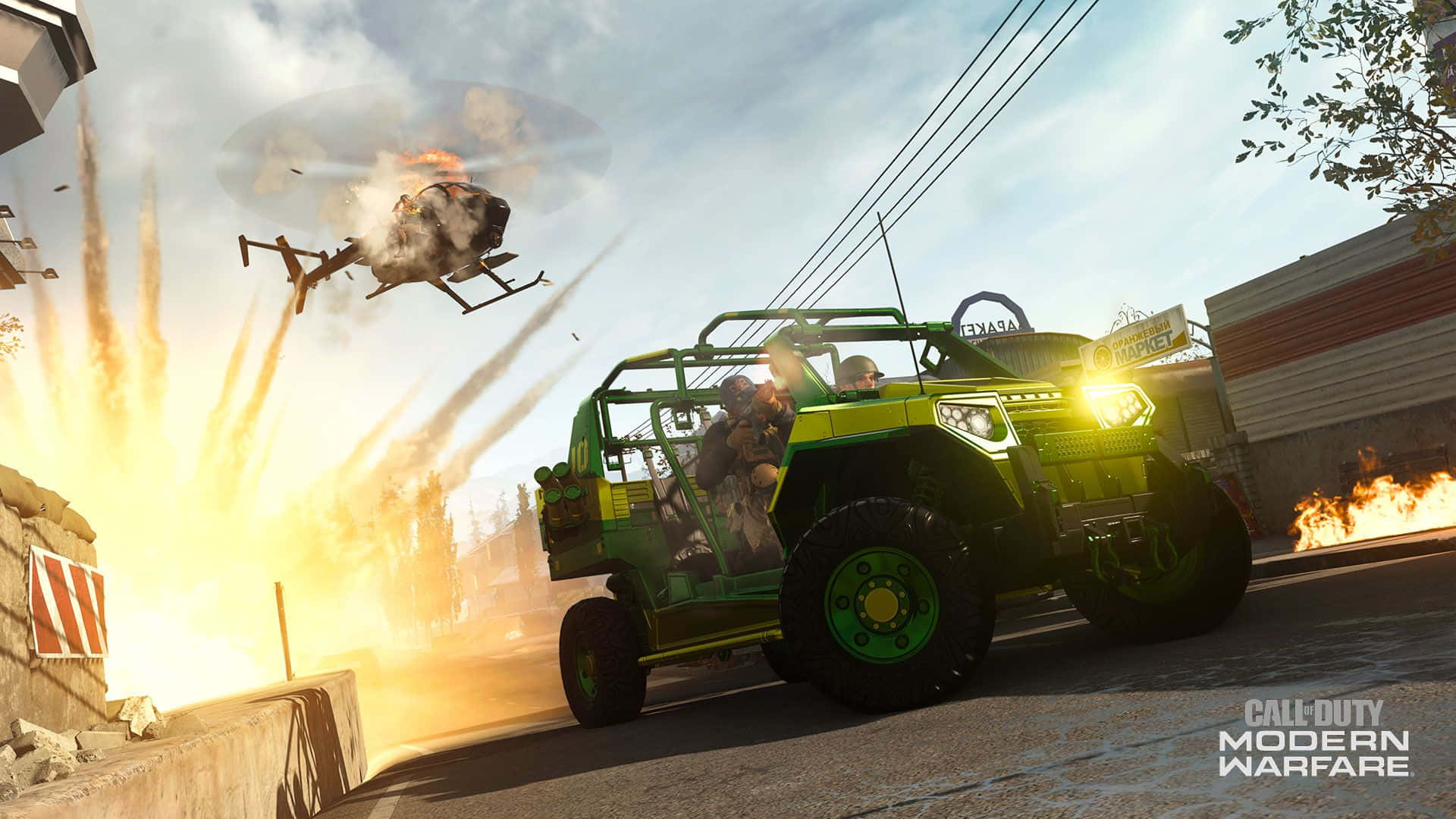 Call Of Duty Vehicles 桌布 壁紙 — 一輛綠色裝甲車在城市街道上疾駛，身後一架燃燒的直升機正在爆炸。