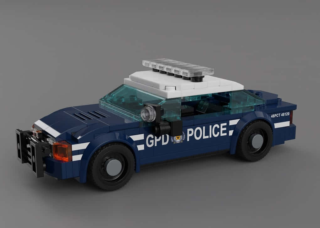 Gotham City Police Department 桌布 壁紙 — 一輛藍白相間的LEGO警車，配有透明車窗和車頂燈，放置在灰色工作室背景上。