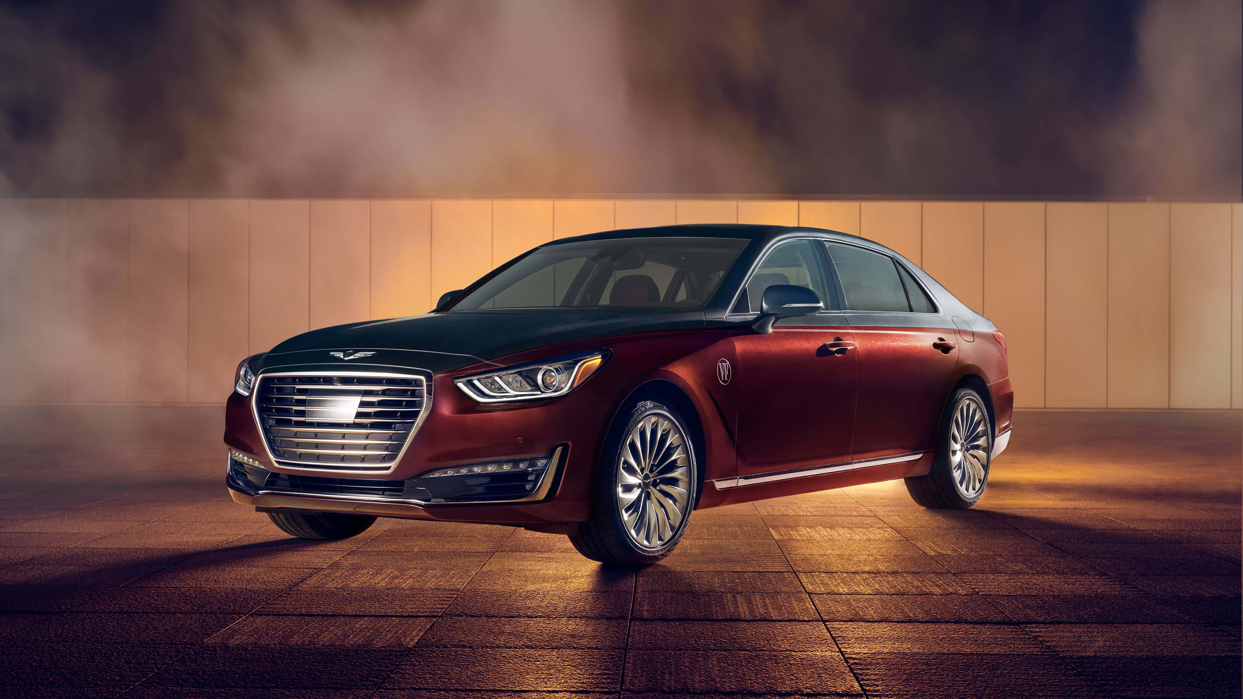 Genesis G90 桌布 壁紙 — 一輛豪華的紅黑轎車在溫暖的攝影棚燈光下閃閃發光，煙霧繚繞其時尚的現代設計。