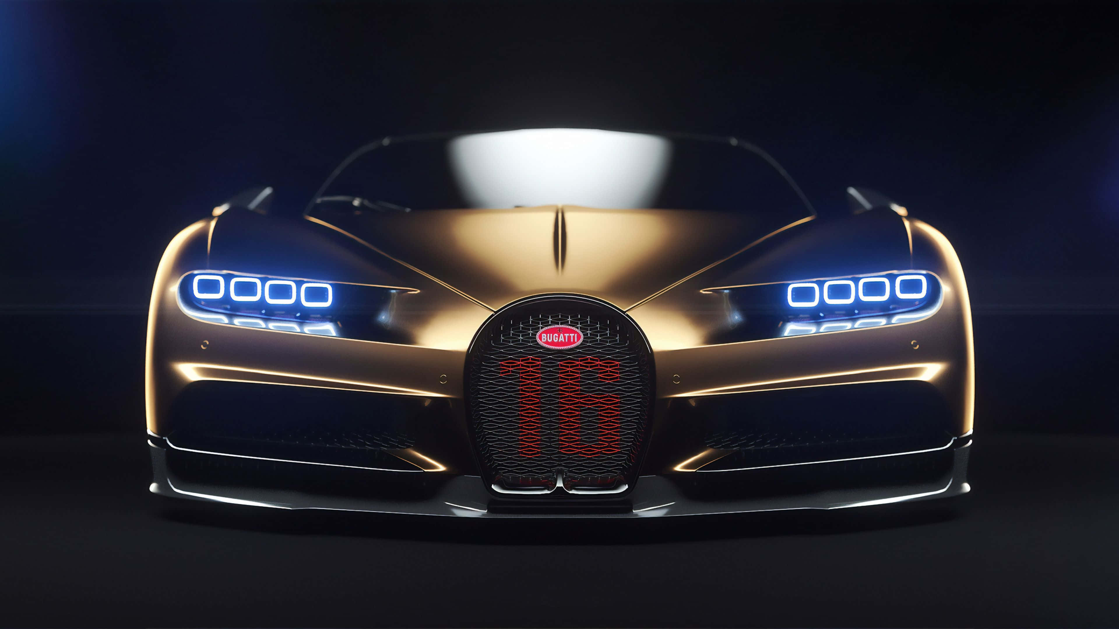 Best Bugatti 桌布 壁紙 — 一輛金色Bugatti超跑，帶有藍色發光頭燈和紅色「16」格柵徽章，在黑暗的攝影棚中直視前方。