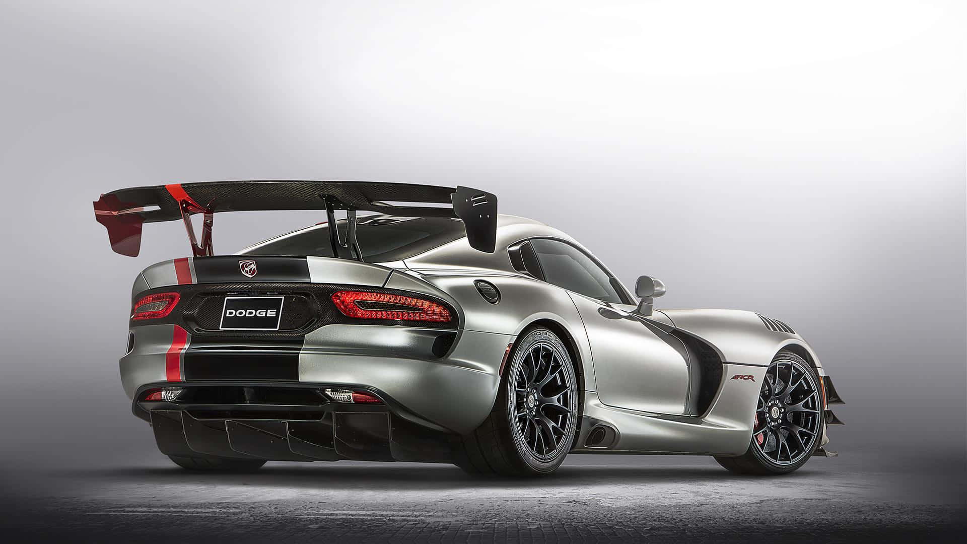 Dodge 桌布 壁紙 — 一輛銀色Dodge Viper ACR，帶有紅色點綴和大型後擾流板，在極簡灰色工作室背景前蓄勢待發。