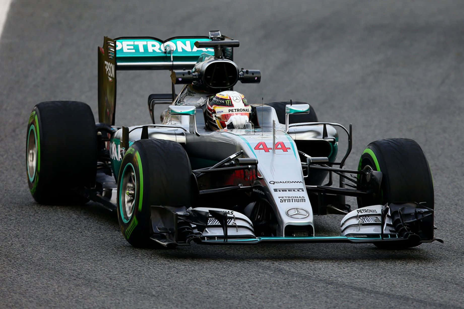 HD F1 2016 桌布 壁紙 — 一輛銀色和藍綠色的 Formula 1 賽車，編號 44，在陰天潮濕的賽道上疾馳。