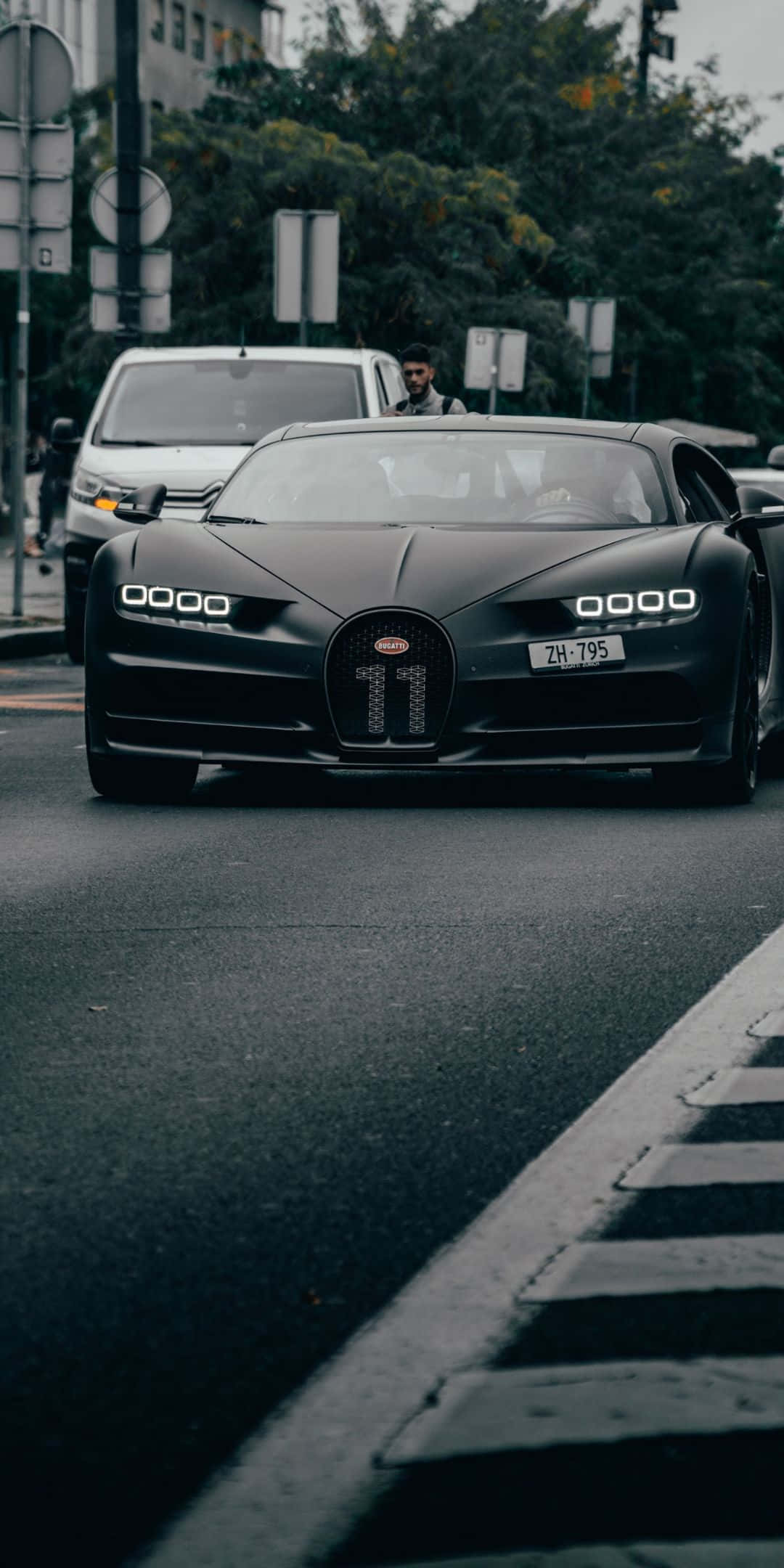 Black Car 桌布 壁紙 — 一輛霧面黑色的Bugatti Chiron，水箱護罩上有11號，在陰天的主導著城市街道。
