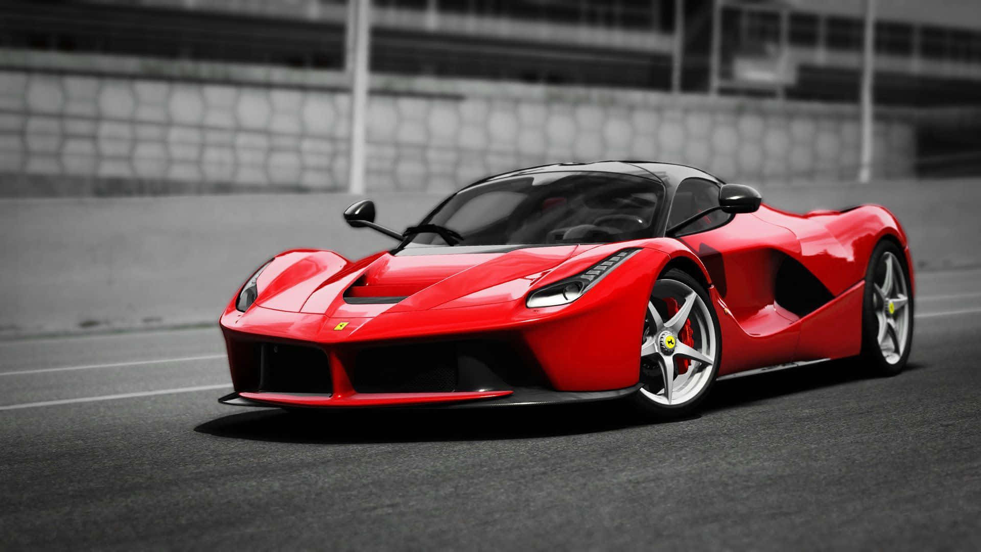 Ferrari Laferrari 桌布 壁紙 — 一輛鮮紅色的法拉利 LaFerrari 跑車在賽道上閃閃發光，黑白背景凸顯其流線型空氣動力學設計。