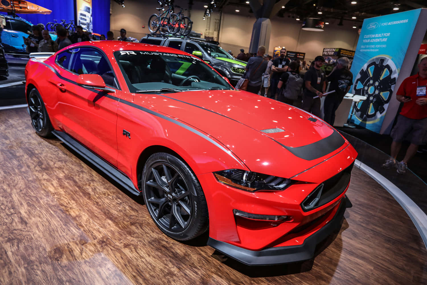 野馬GIF 桌布 壁紙 — 一輛鮮紅色的福特野馬GT350R在車展上展出，具有光澤飾面和黑色點綴。