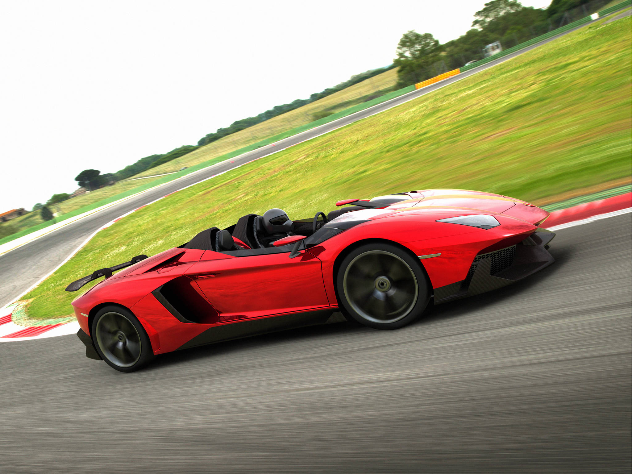 4K Lamborghini 桌布 壁紙 — 一輛鮮紅色的藍寶堅尼 Aventador Roadster 在賽道上疾馳，背景是模糊的綠色草地和天空。