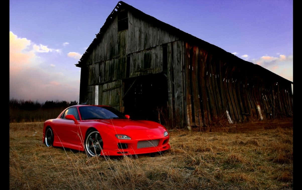 Mazda 桌布 壁紙 — 一輛鮮紅色跑車停在乾草上，背景是夕陽下風化的木製穀倉。