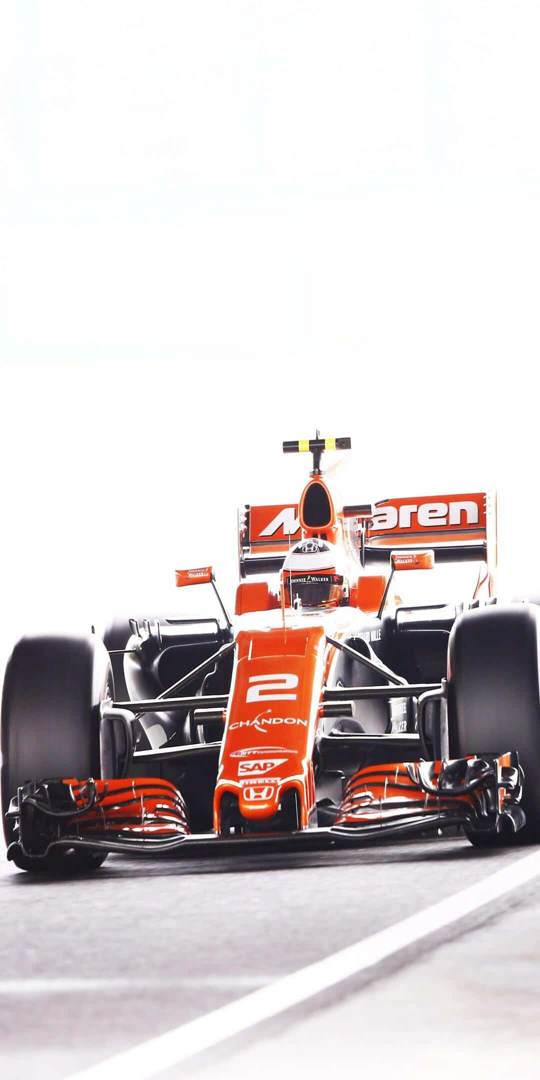 F1 桌布 壁紙 — 一輛鮮豔的橙色一級方程式賽車，車號2，在明亮的白色天空下高速行駛在賽道上。