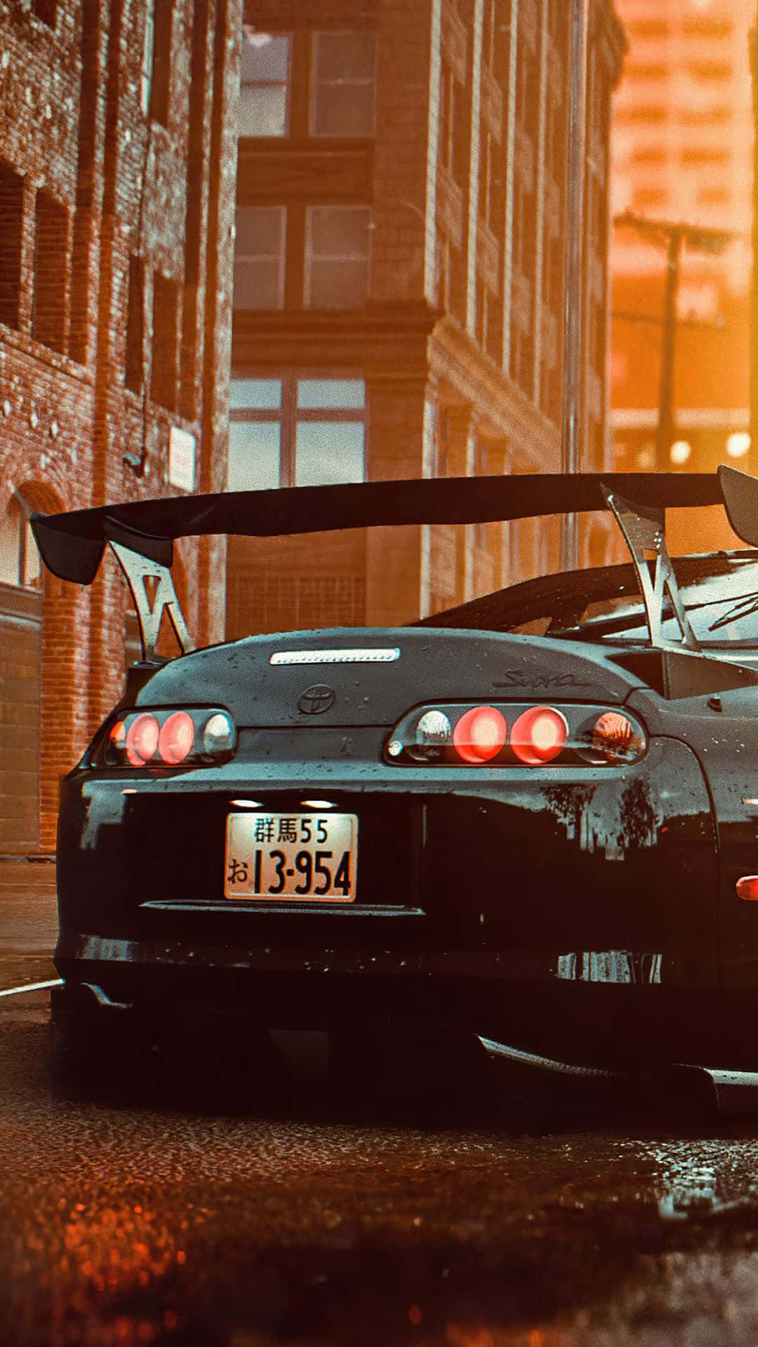 黑色豐田Supra，發光的紅色尾燈，停在日落時分濕漉漉的城市街道上。 — Toyota Supra Mk4 壁紙