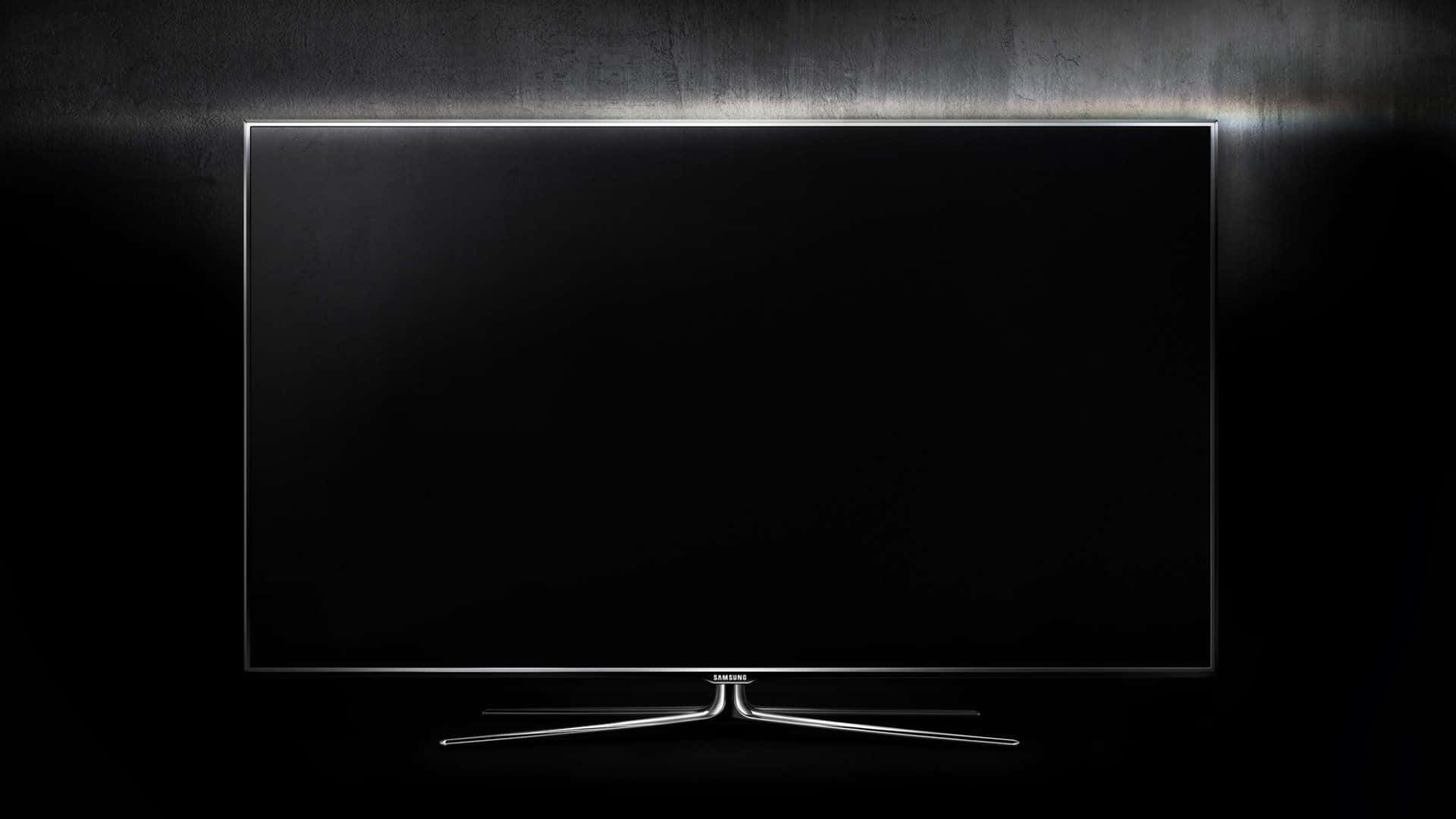 Television Set 桌布 壁紙 — 一部時尚現代電視，黑色螢幕和銀色支架，在深色紋理牆壁上由發光燈條照亮。