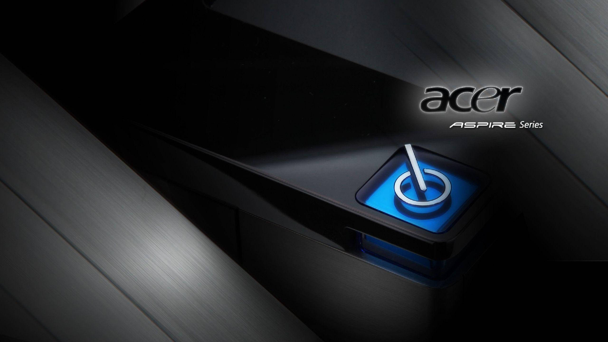 品牌 桌布 壁紙 — 一部時尚的黑色Acer Aspire筆記型電腦，在戲劇性燈光下帶有發光的藍色電源按鈕。