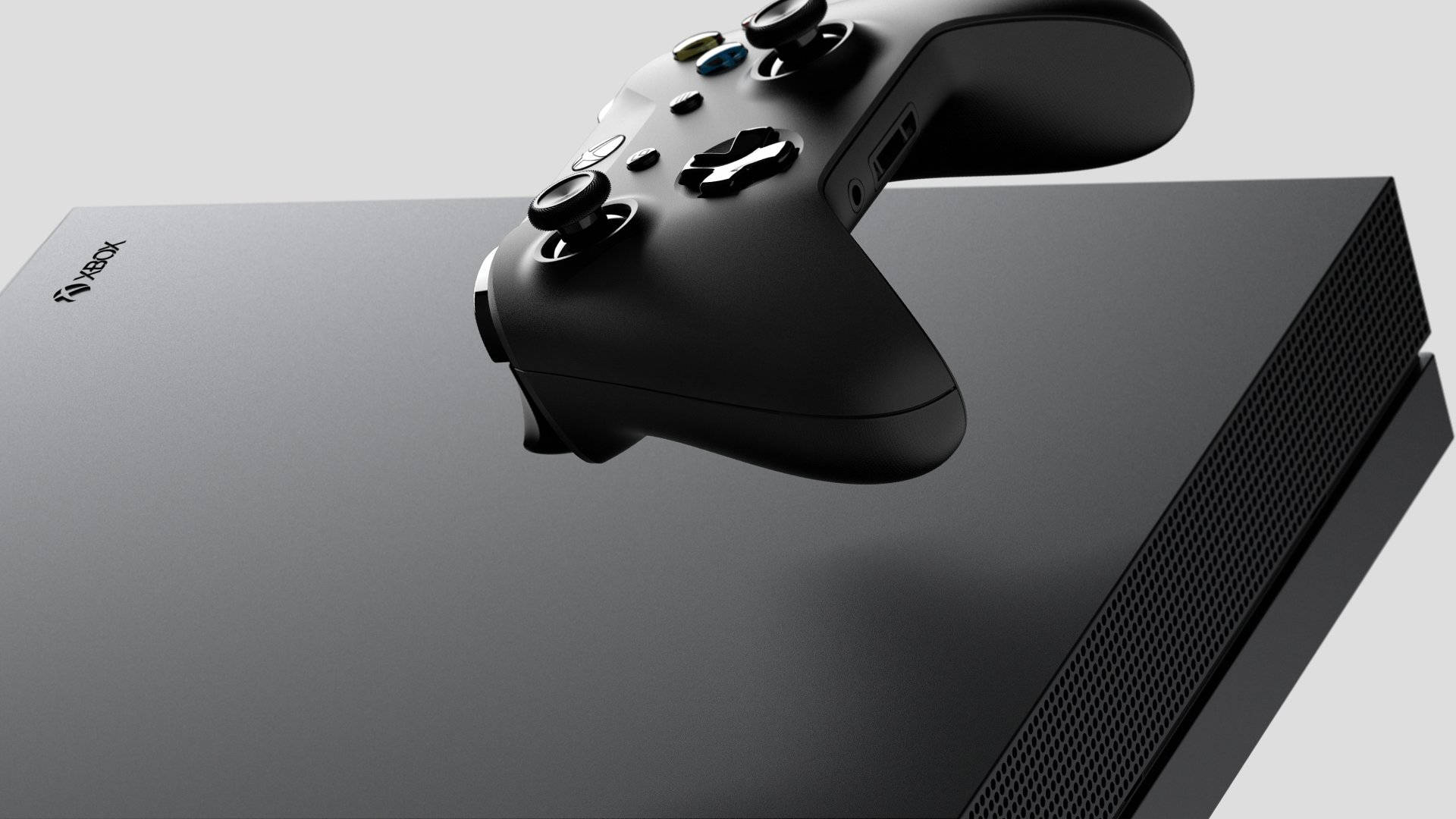 Xbox 桌布 壁紙 — 一部時尚的黑色Xbox主機，上面放著一個相配的控制器，背景為簡約灰色。